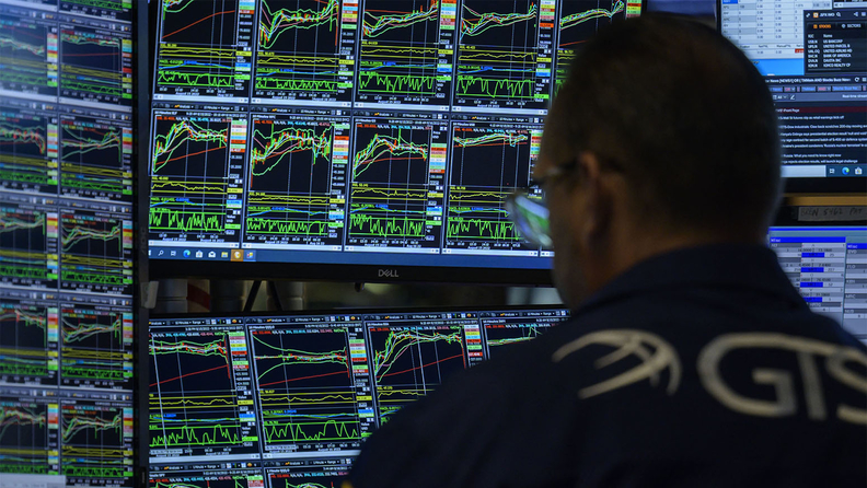 Traders work during the opening bell at the New York Stock Exchange.